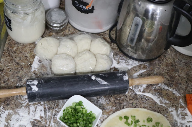 green onion cake prep, dough rolled out, rolling pin.