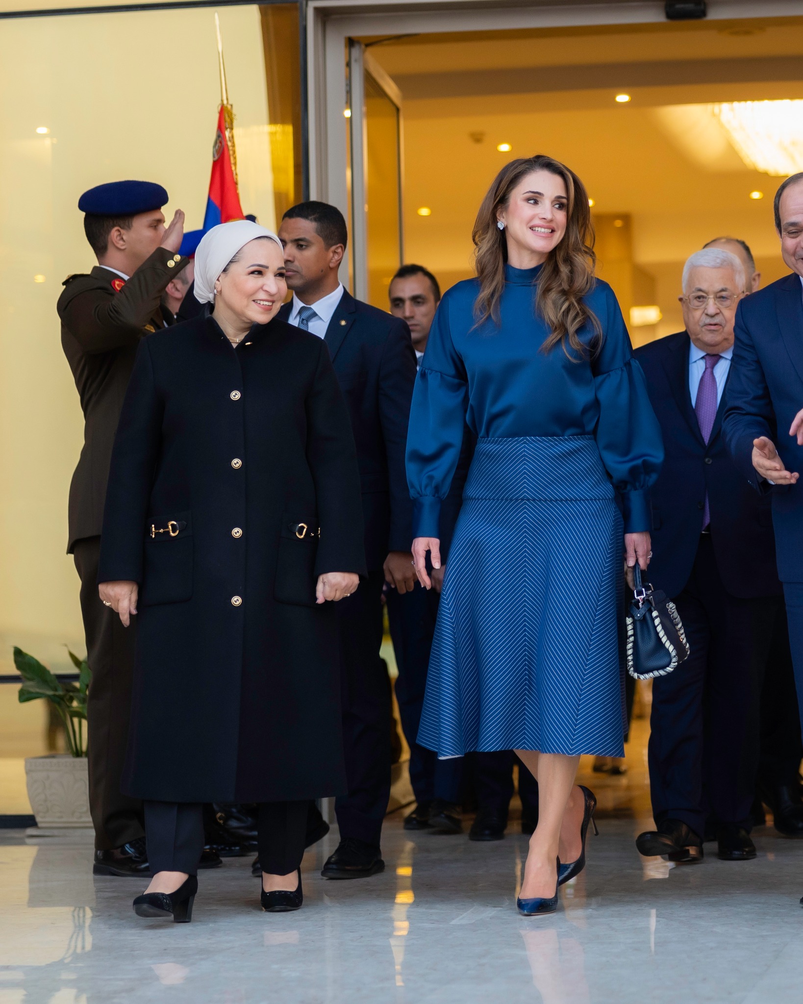 Queen Rania was wearing a By Malene Birger blouse with Fendi Striped Cotton And Silk-blend Skirt In Navy. Rania was wearing blue pumps and carrying her Fendi Selleria Peekaboo bag