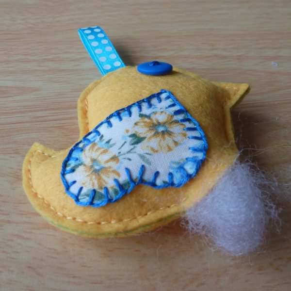 Adding fiber fill into the plush hanging bird ornament design