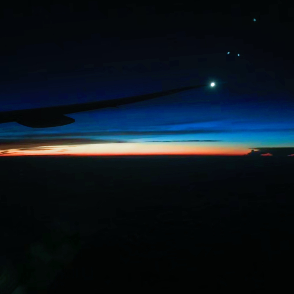 Great sunset views above the clouds outside the plane window