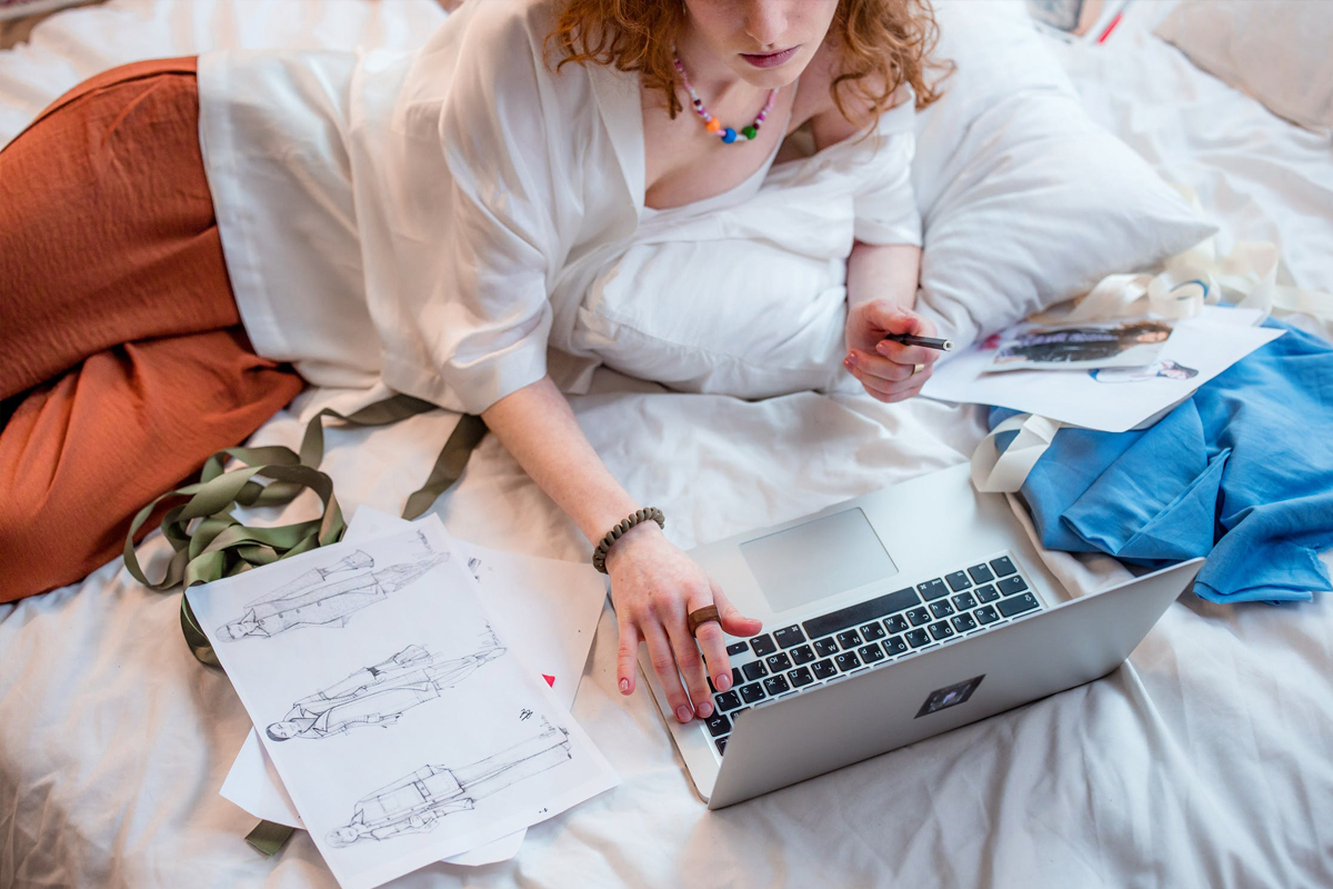 woman in bohemian clothes is working on laptop
