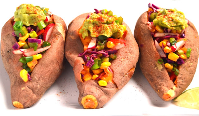 These Chipotle Stuffed Sweet Potatoes are fresh and full of flavor! They are packed full of vegetables and topped with flavorful guacamole. www.nutritionistreviews.com