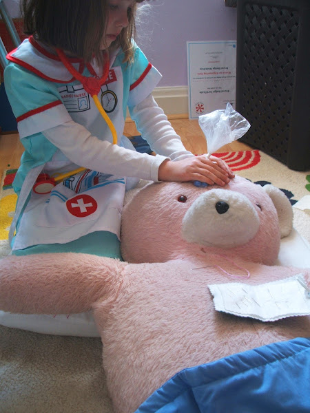 girl nurses her teddy bear