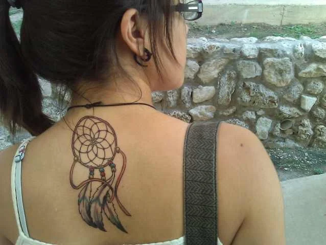 vemos a una linda mujer con un tatuaje de atrapasueños muy femenino