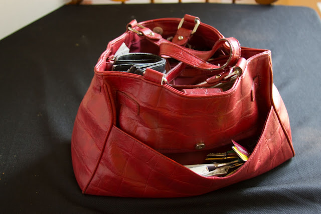 red purse filled with stuff