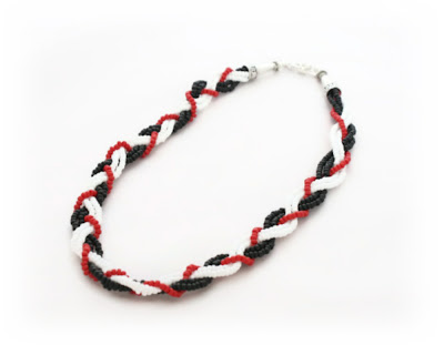 A black, white & red seed bead plaited necklace by Lottie Of London