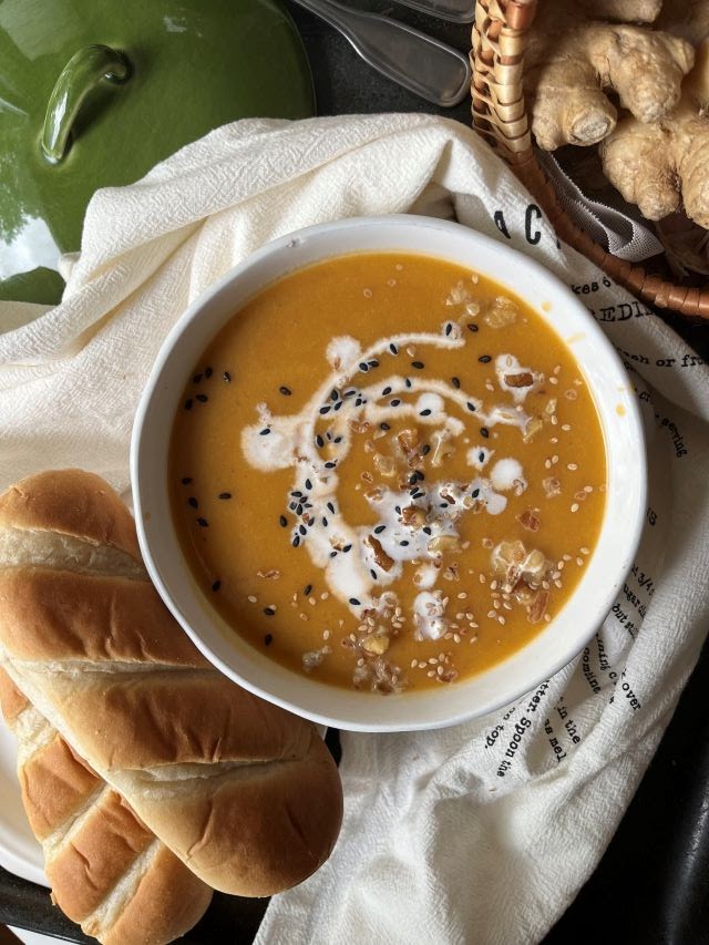 Vegan Carrot, Ginger and Sweet Potato Soup with black sesame seeds and walnuts and dinner rolls