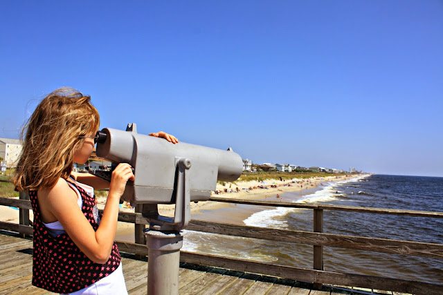 Taking a peek through a scope on the pier at Kure Beach in North Carolina