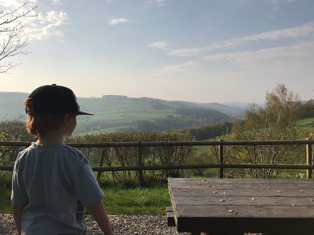 Imaging showing a little boy looking out into the peak district hills