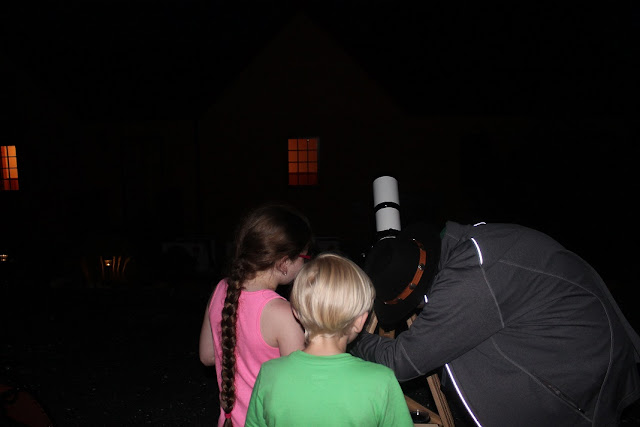 people looking inside the telescope