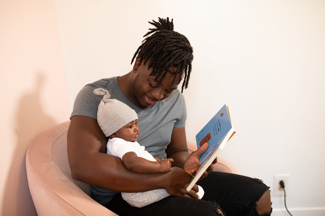 A dad reading a book for his child