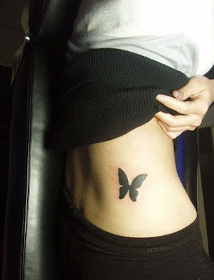 black butterfly tattoo design on the lower back