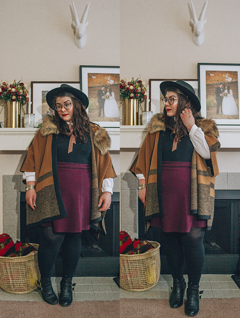 An outfit of a black wide brim fedora, brown faux fur collar poncho, peter pan collar blouse, black sleeveless dress, purple chevron print skater skirt, black tights and black heeled buckle boots.