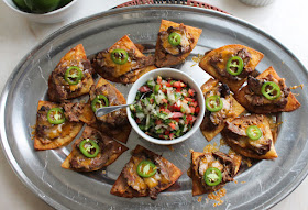 Food Lust People Love: Crunchy fried tortilla triangles topped with refried beans, fajita beef, cheese and jalapeños, these beef fajita nachos compuestos can also be made with store-bought chips. This recipe can also be a main course, as it was for me years ago. You can totally add some shredded lettuce to make you feel better about making this a full meal. 