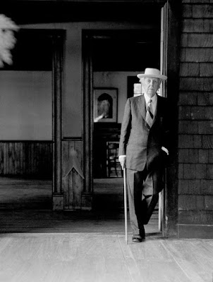 Frank Lloyd Wright standing outside the chapek building in Taiesinm Wisconsin 1957