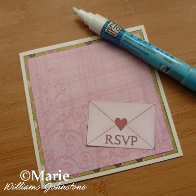 Using a zig glue pen to stick on a mini envelope embellishment