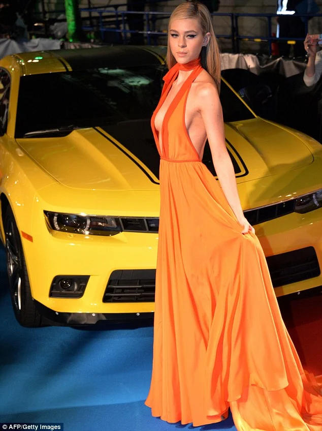 Nicola Peltz goes braless in an orange gown at the 'Transformers: Age of Extinction' Tokyo premiere