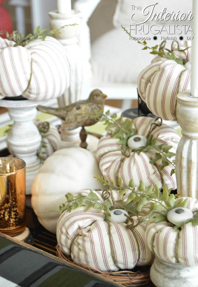 Here I show you how to salvage an old ticking stripe slipcover and kitchen cabinet knobs into pretty fabric pumpkins with farmhouse style for fall.