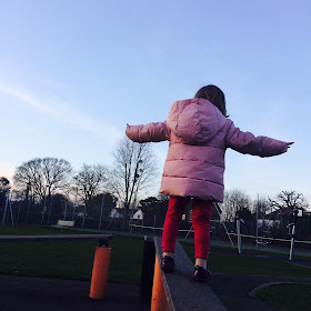  Parenting my kids isn't what I expected becuase.... Girl trying to balance at the playground.