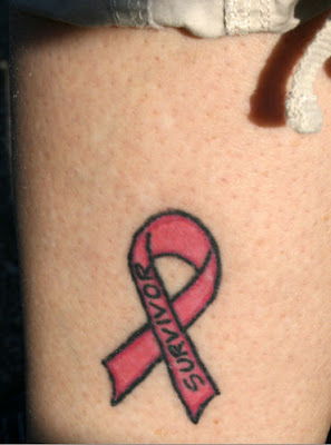 A pink ribbon which says,