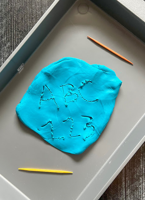 letters and numbers written in blue play dough.