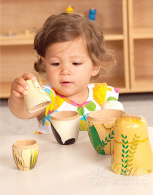 namc montessori developing independence in toddlers girl working with nesting dolls limited choice