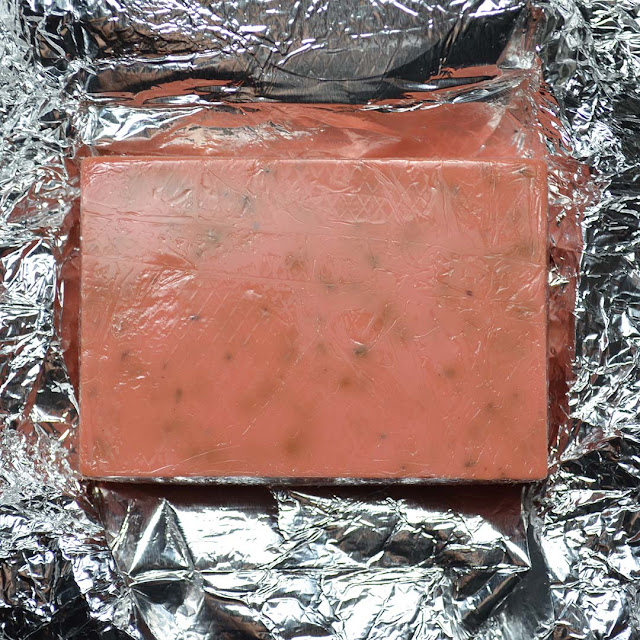 soap bar with rose buds on top of foil wrapping