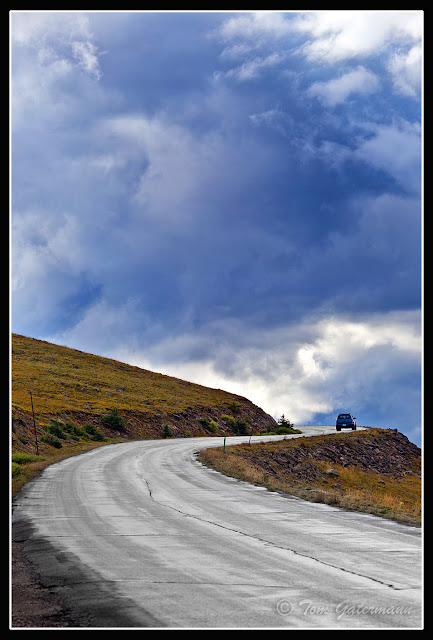 A Lone Car Drives Up Mount Evans Road on Mount Evans.