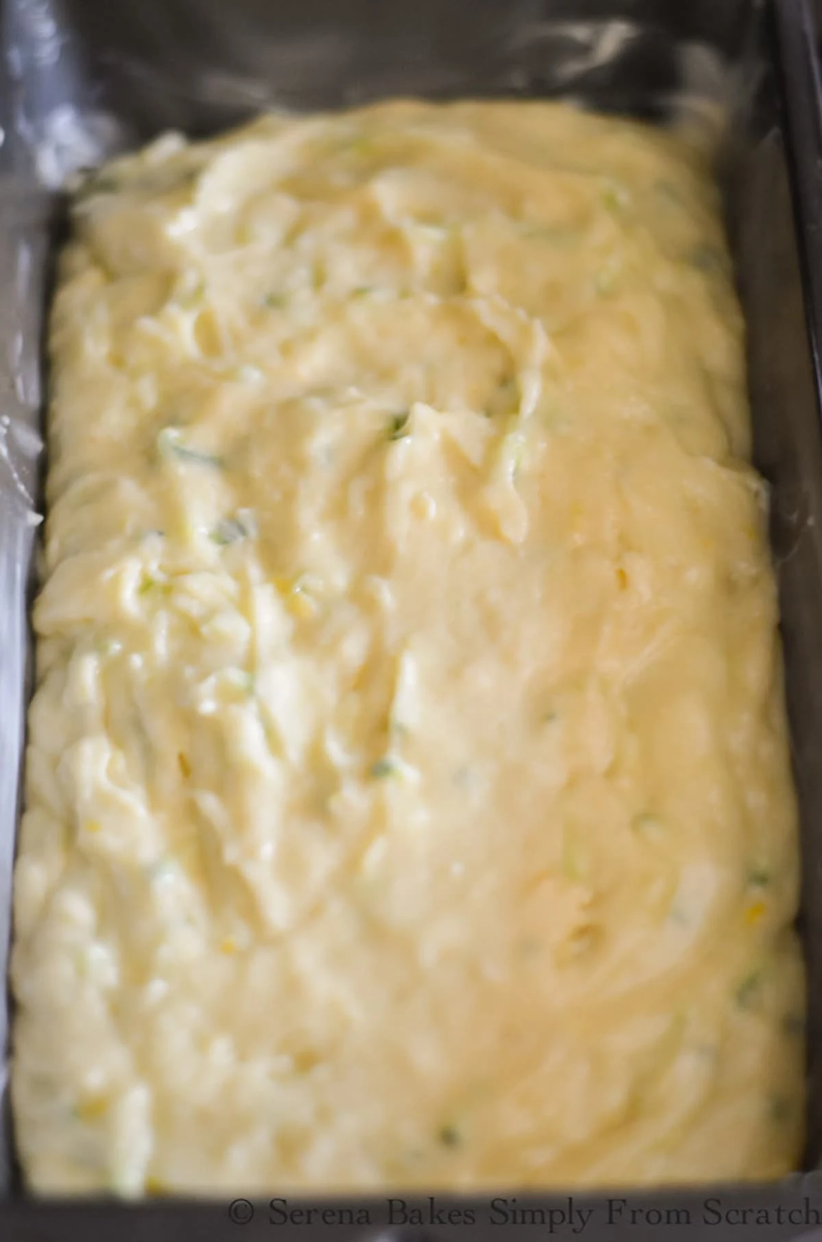 Lemon Zucchini Bread batter spread in a bread pan.