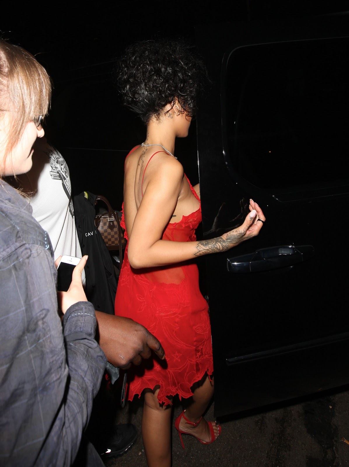 Rihanna in see-through red scarlet dress while nightclubbing in West Hollywood.
