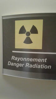 Yellow and black radiation warning sign outside the treatment room