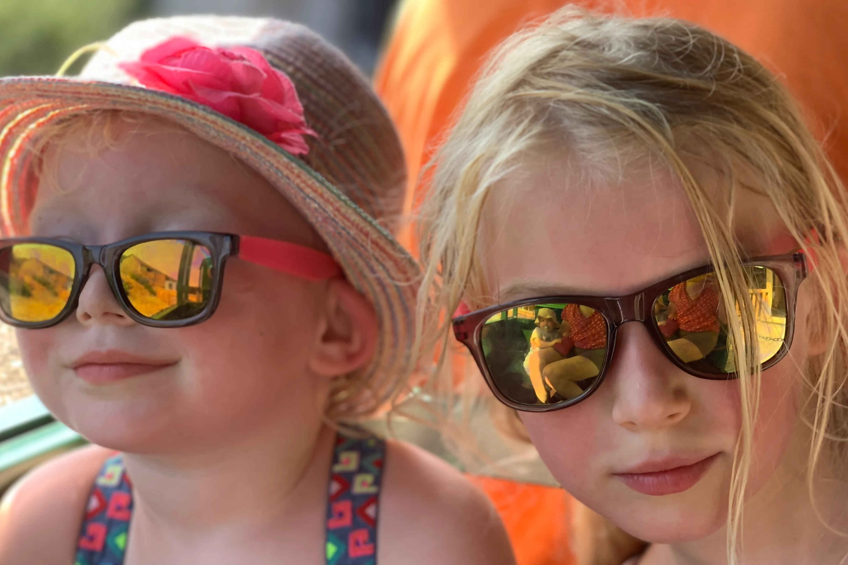 children wearing sunglasses and hats on a hot summers day out in Essex