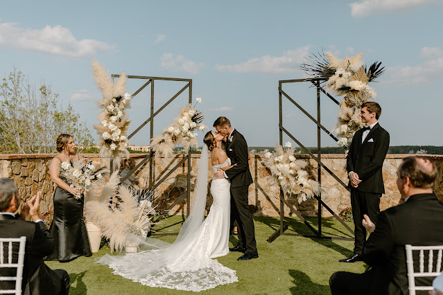 wedding ceremony with black decor couple kissing