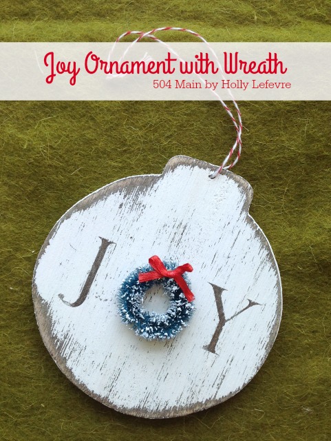 A handmade wood ornament adorned with a wreath.