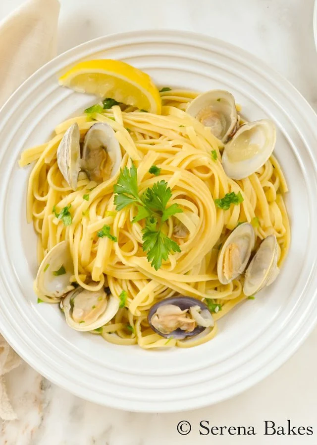 Clams with Linguine in a White Wine Butter Sauce recipe is a favorite for dinner. It's elegant yet easy to make from Serena Bakes Simply From Scratch.