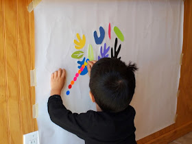child sticking on stickers onto matisse inspired murals