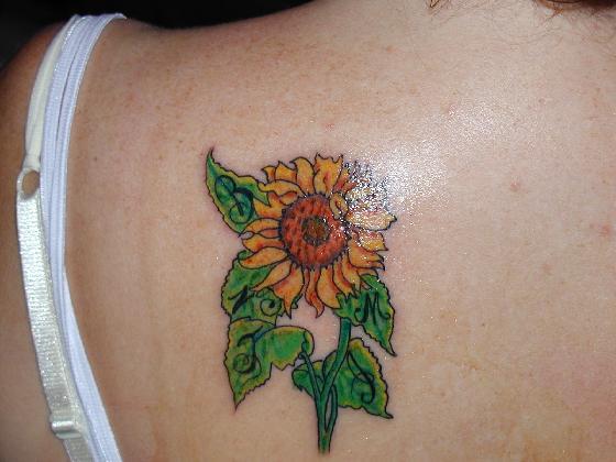 Feast you eyes on the great quality sunflower tattoo pictures below.