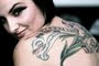 girls upper back tattoos with flower tattoo designs