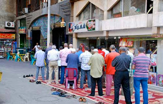 Men Praying in Street - Cairo, Egypt