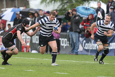 Hooker Joey Mount stiff arms an SDSU forward while Flanker Nate Maughan follows in support