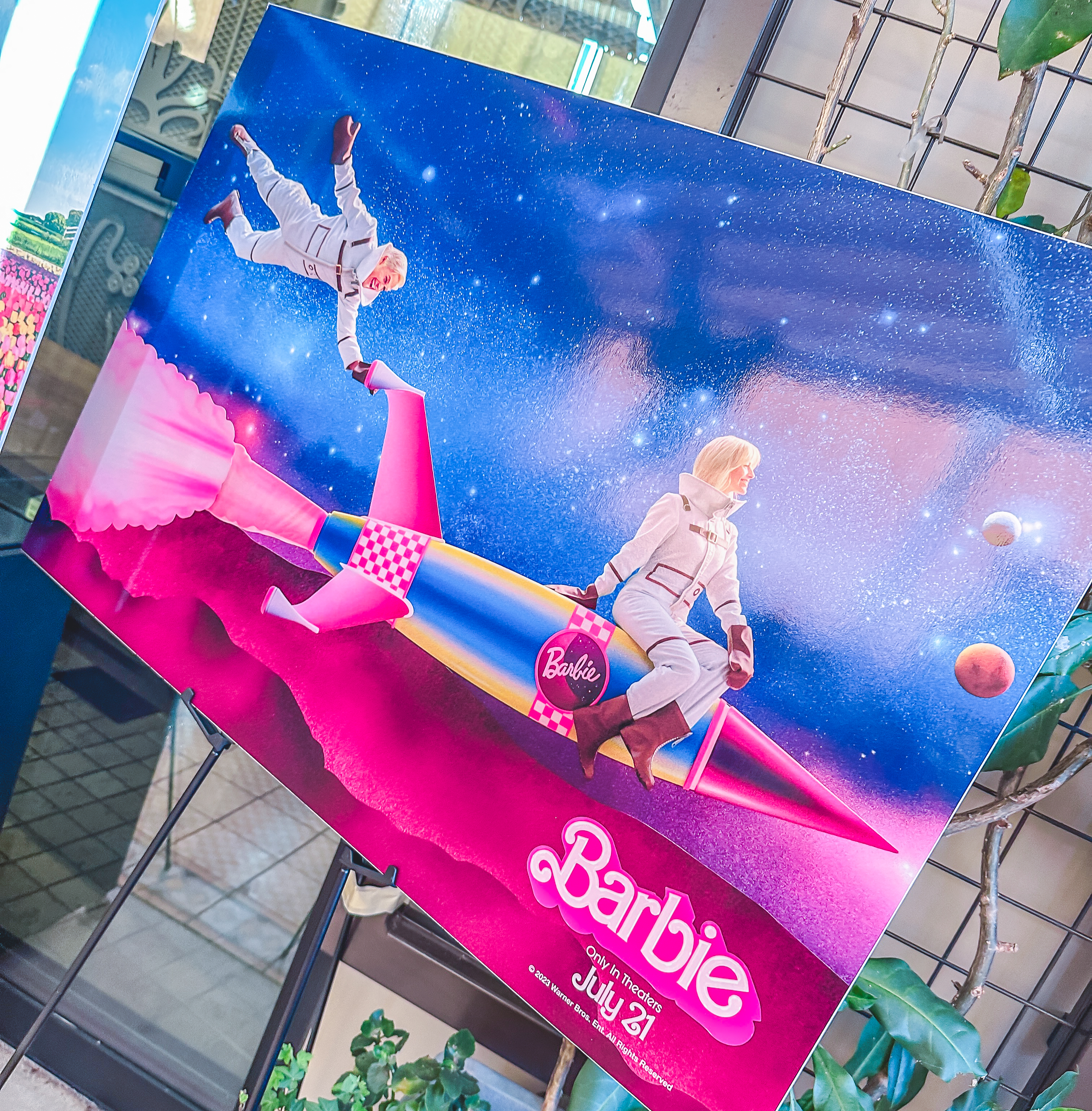 Poster of Barbie and Ken in astronaut suits riding a pink rocketship