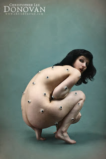 Photo of a nude woman covered in eyeballs