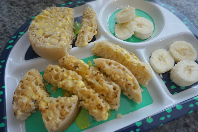 plate with crumpets and a sliced banana