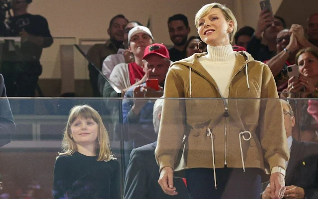 Princess Charlene wore a double face hooded jacket by Louis Vuitton. Loro Piana white cashmere turtleneck sweater