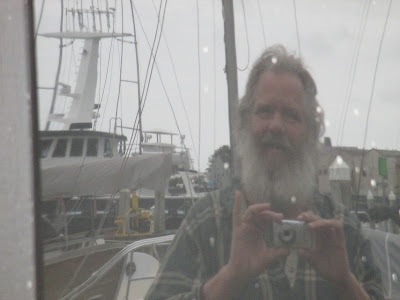 reflection of me in a window at Woodley Island Marina in Eureka, CA - Gregory Vanderlaan