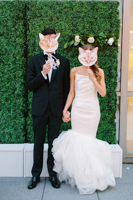 bride and groom with cat face props