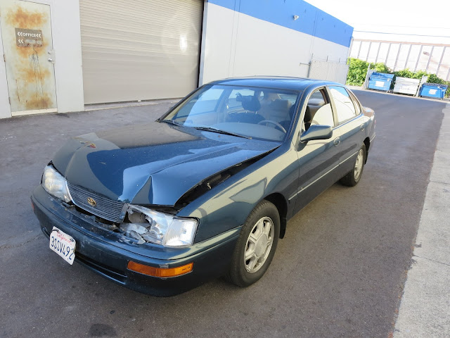 Toyota Avalon with collision damage before repair at Almost Everything Auto Body