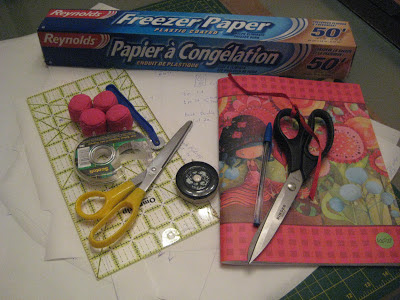 Freezer paper, scissors, tape measure, scotch tape, pattern weights, tracing wheel, ruler, self healing mat, pen and notebook.