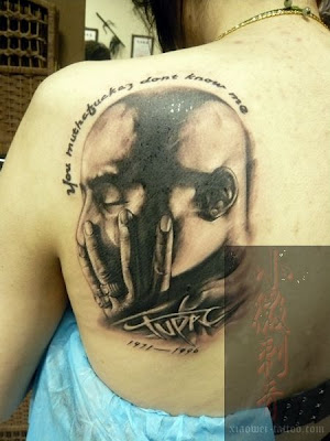 a thinker portrait tattoo on the back
