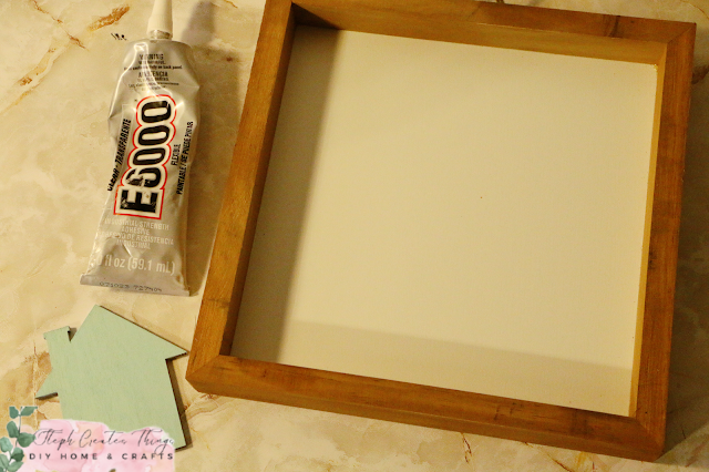 Adhesive, painted wooden house, and wooden sign